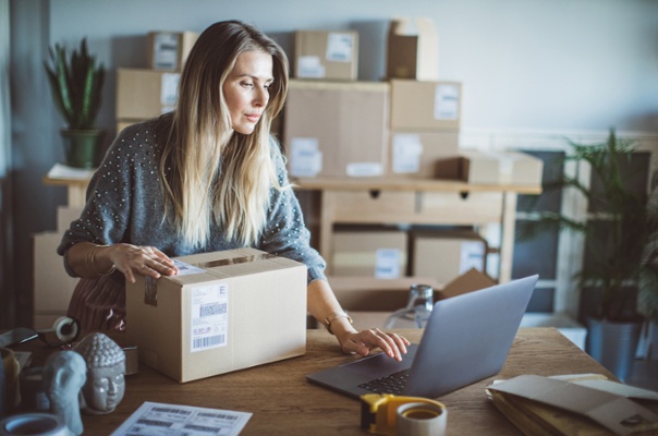 Business Owner Checking Shipping Rates While Preparing Orders