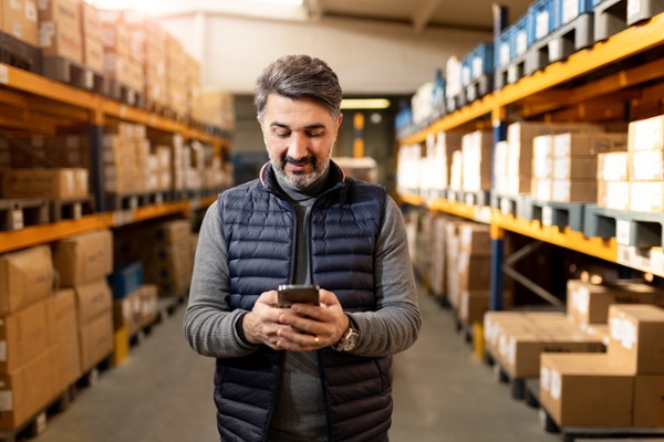 Business owner looking over  business results after choosing between FreightClub vs. Real-Time Shipping Quotes-1