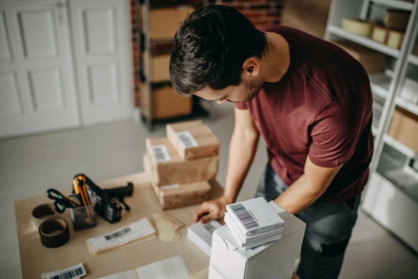 Business owner packing up orders in his home office