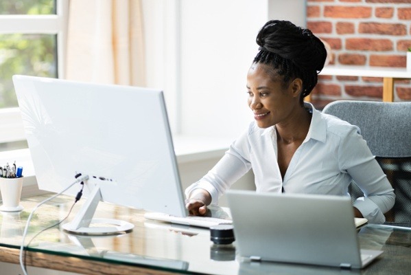 Customer service employee working on a computer in her home office