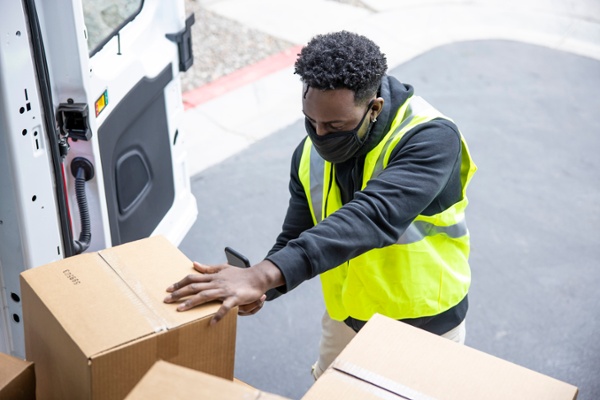 Delivery professional arranging boxes in a shipping van-1