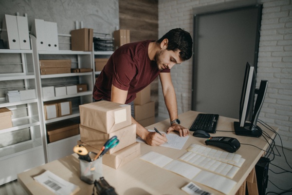 Ecommerce business owner organizing packages for shipment