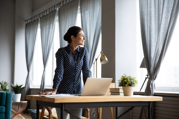 Ecommerce business owner taking a break as a custom shipping object does the work