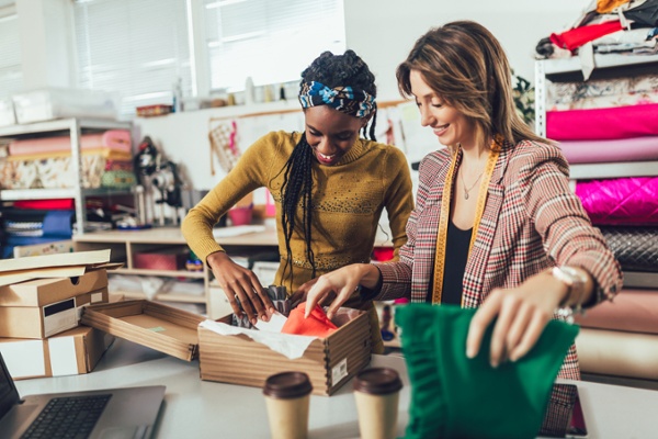 Employees carefully putting products in custom branded packaging