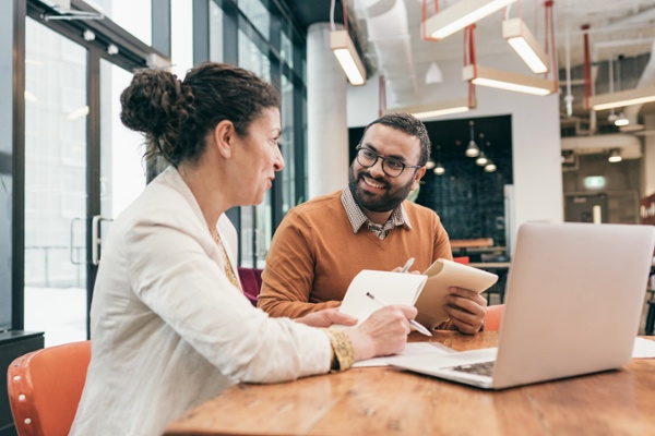 Two small business owners discussing Shopify inventory management