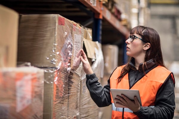 Warehouse employee scanning orders for white glove delivery